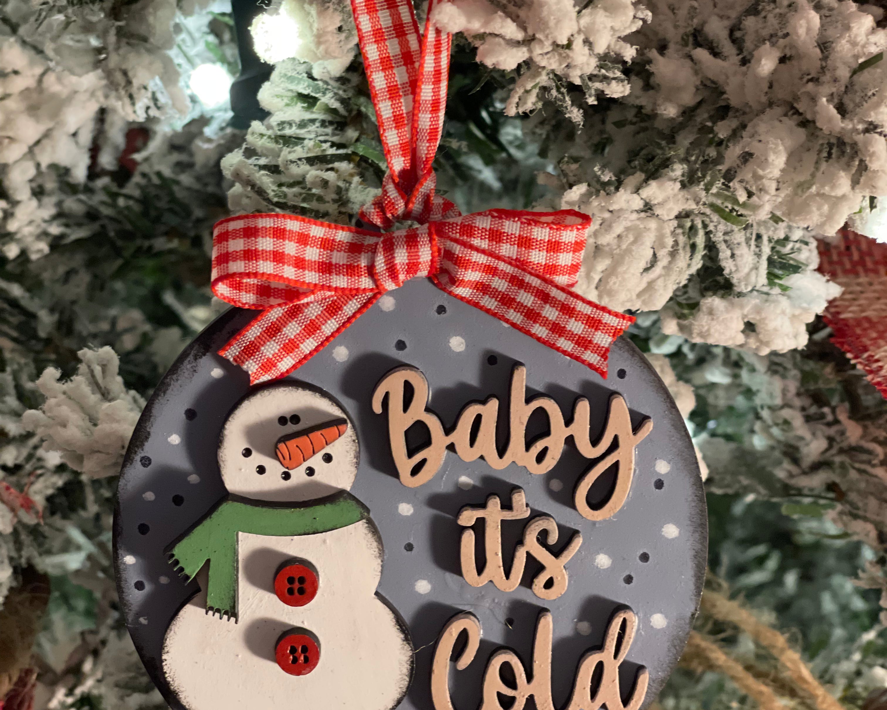 This ornament is displayed hanging on a tree.