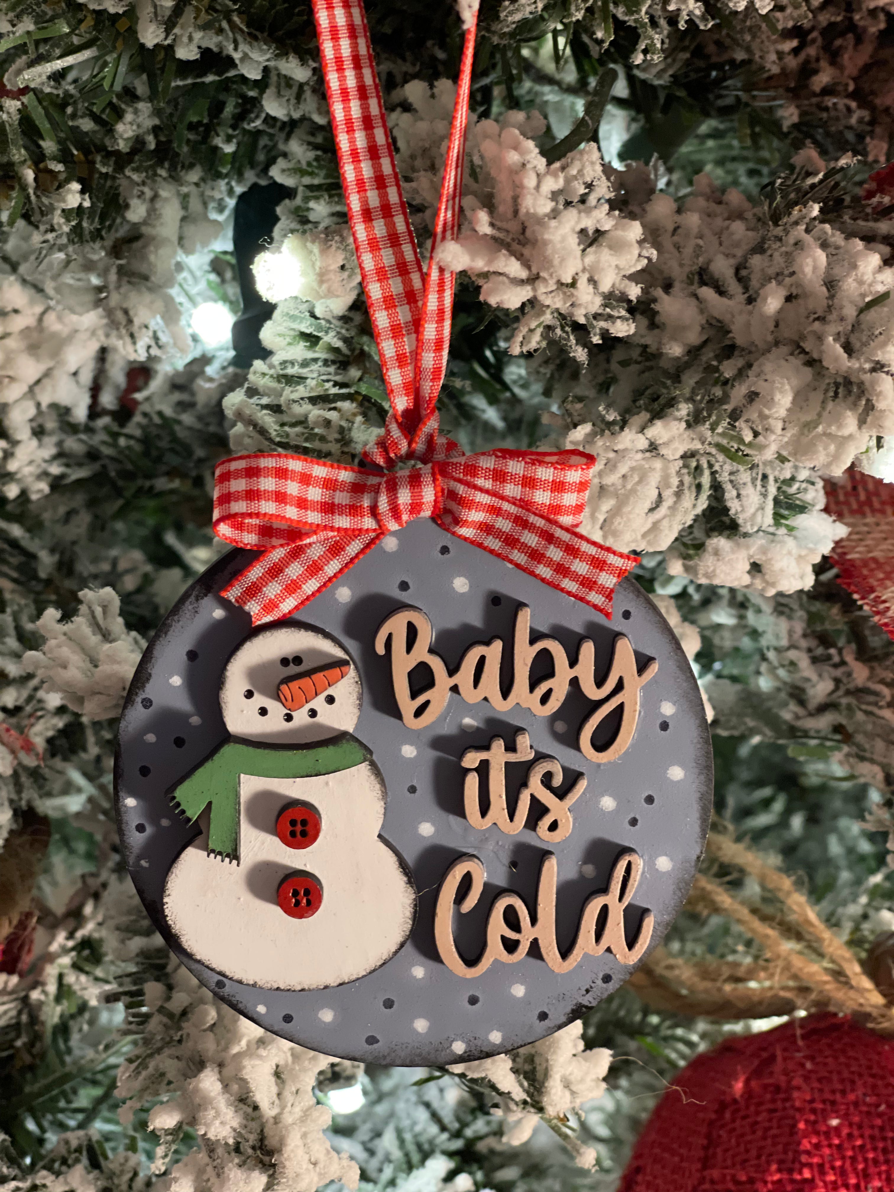 This ornament is displayed hanging on a tree.