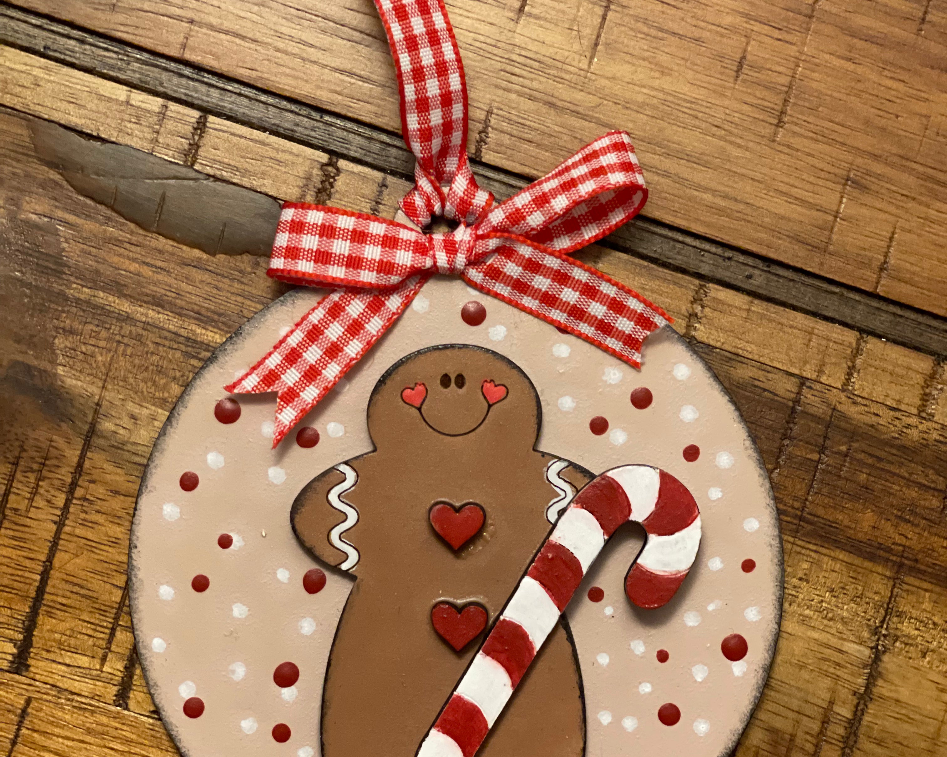 The ornament is displayed laying on a wood table.