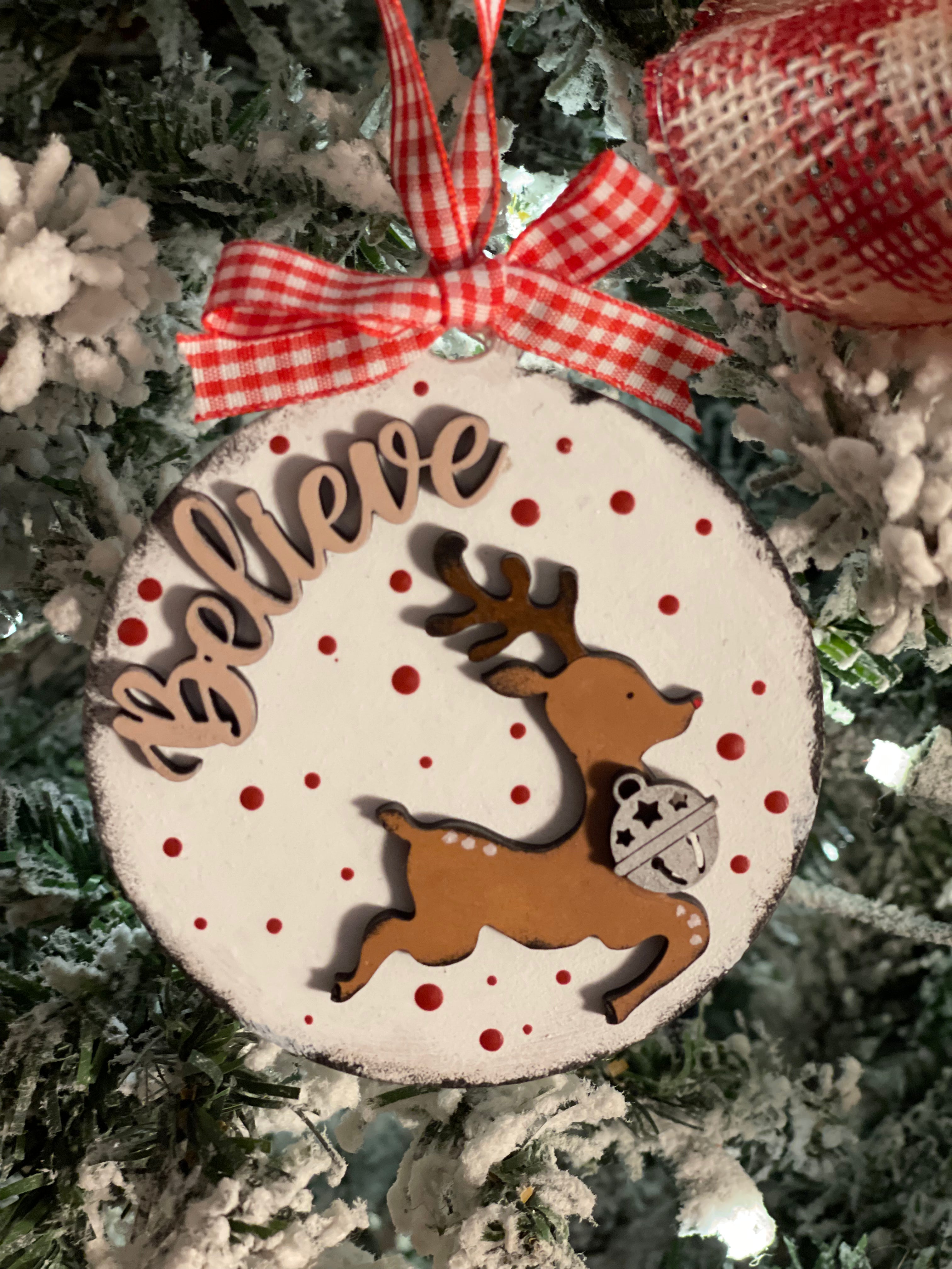 The ornament is displayed hanging on a tree
