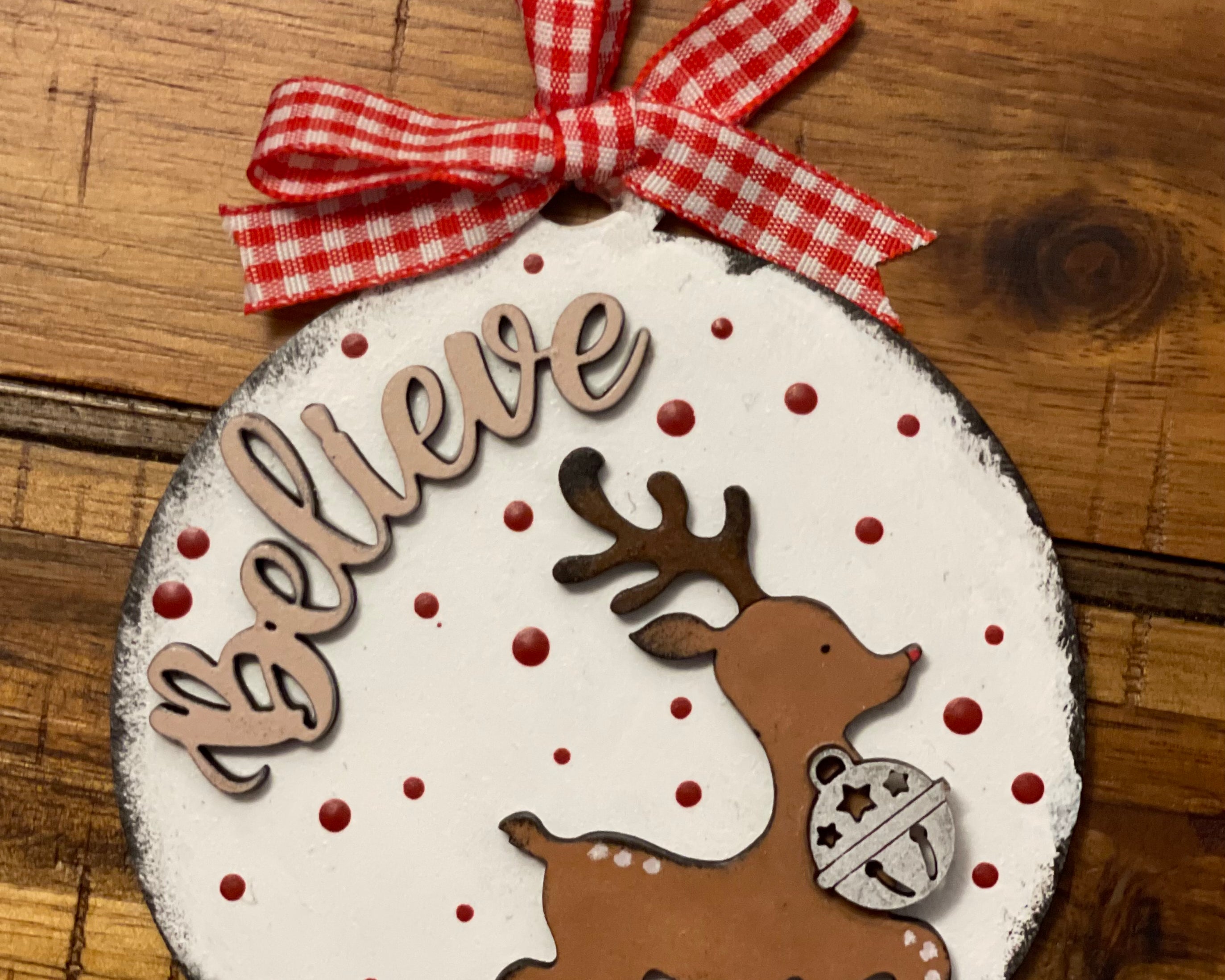 The ornament is shown displayed on a wood table.