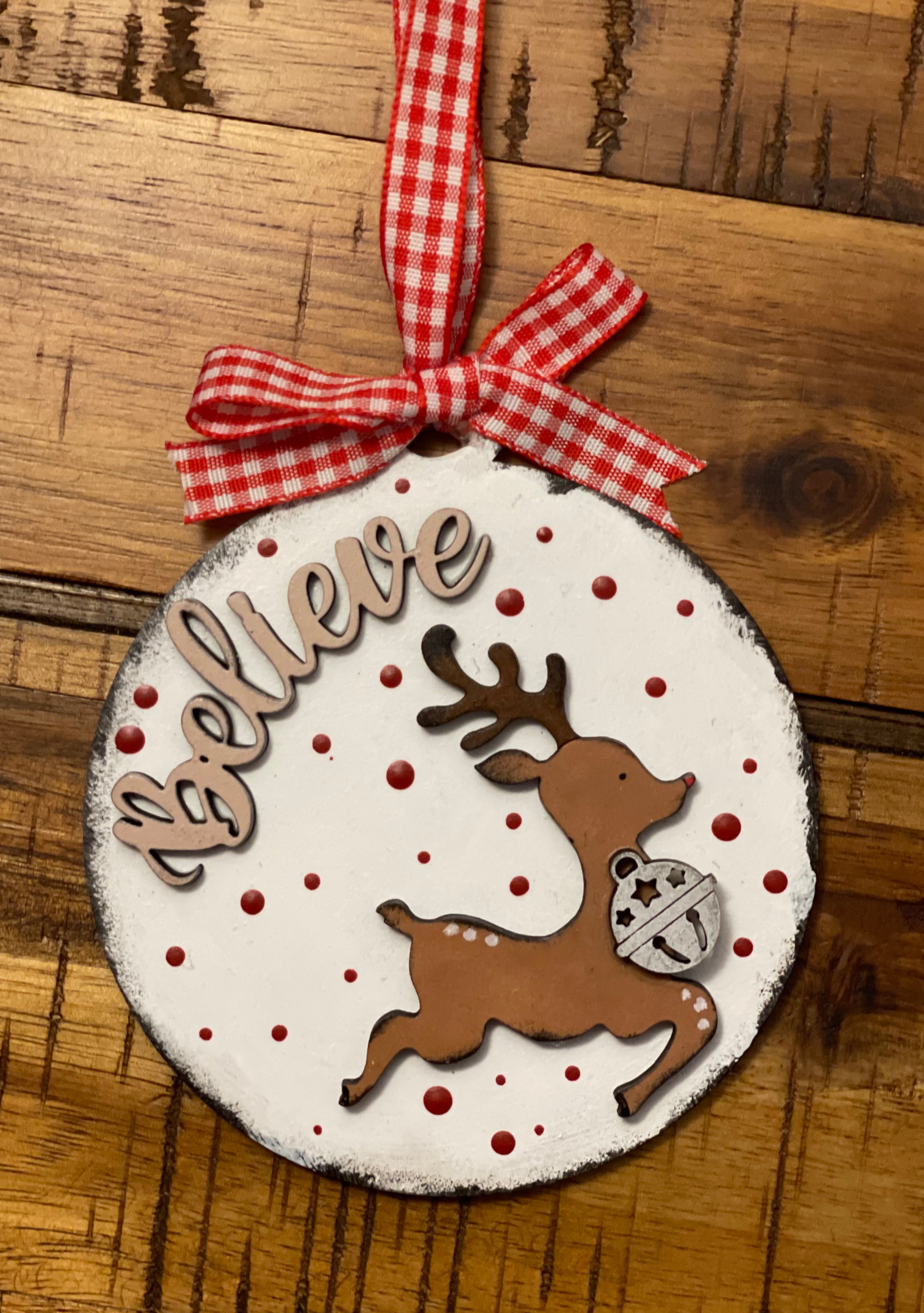 The ornament is shown displayed on a wood table.