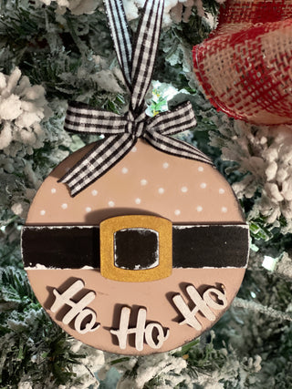 The pink ornament is shown hanging on a tree.