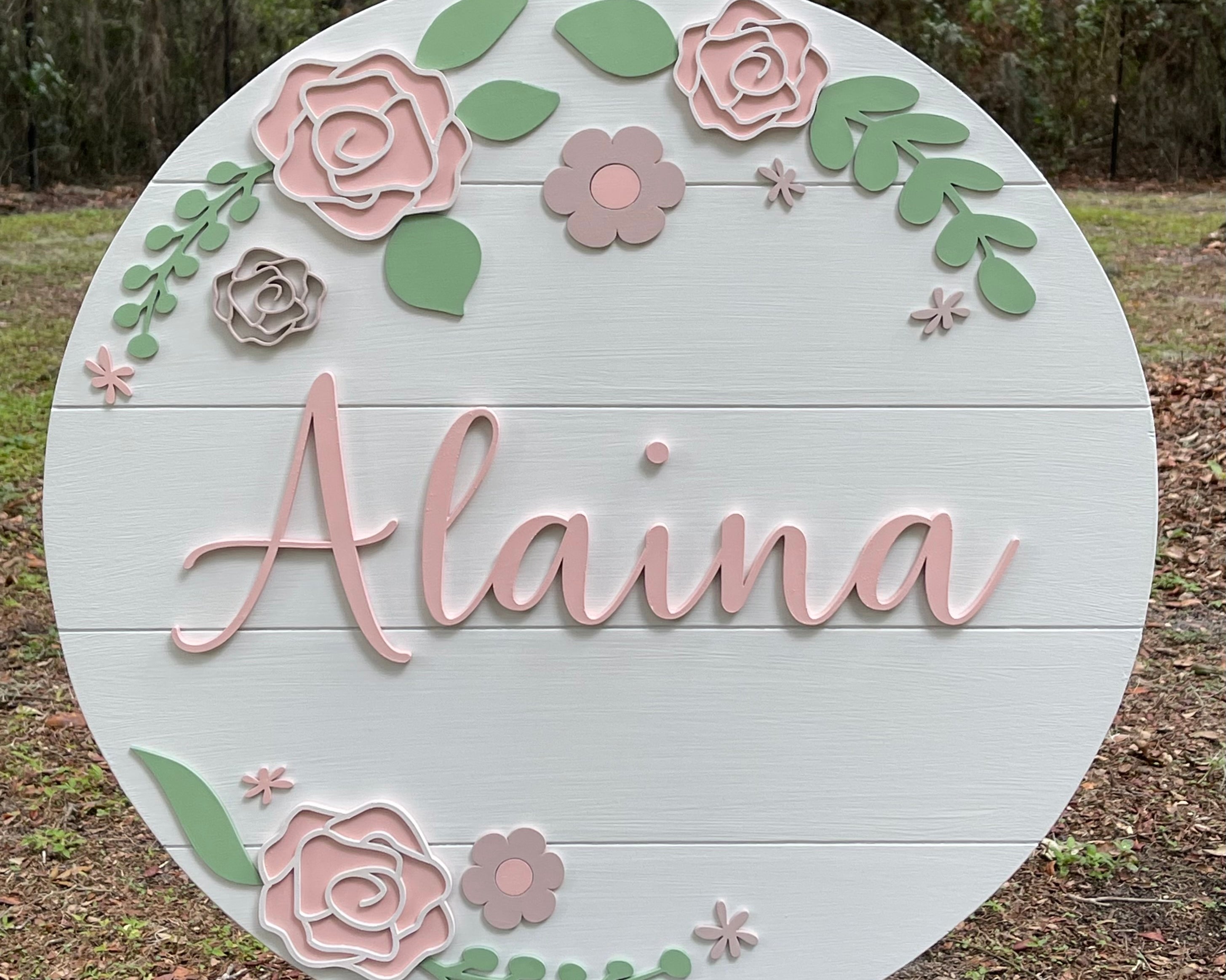 Nursery Baby Name Sign is shown displayed outside on an easel so you can see the colors of the 3D wood.