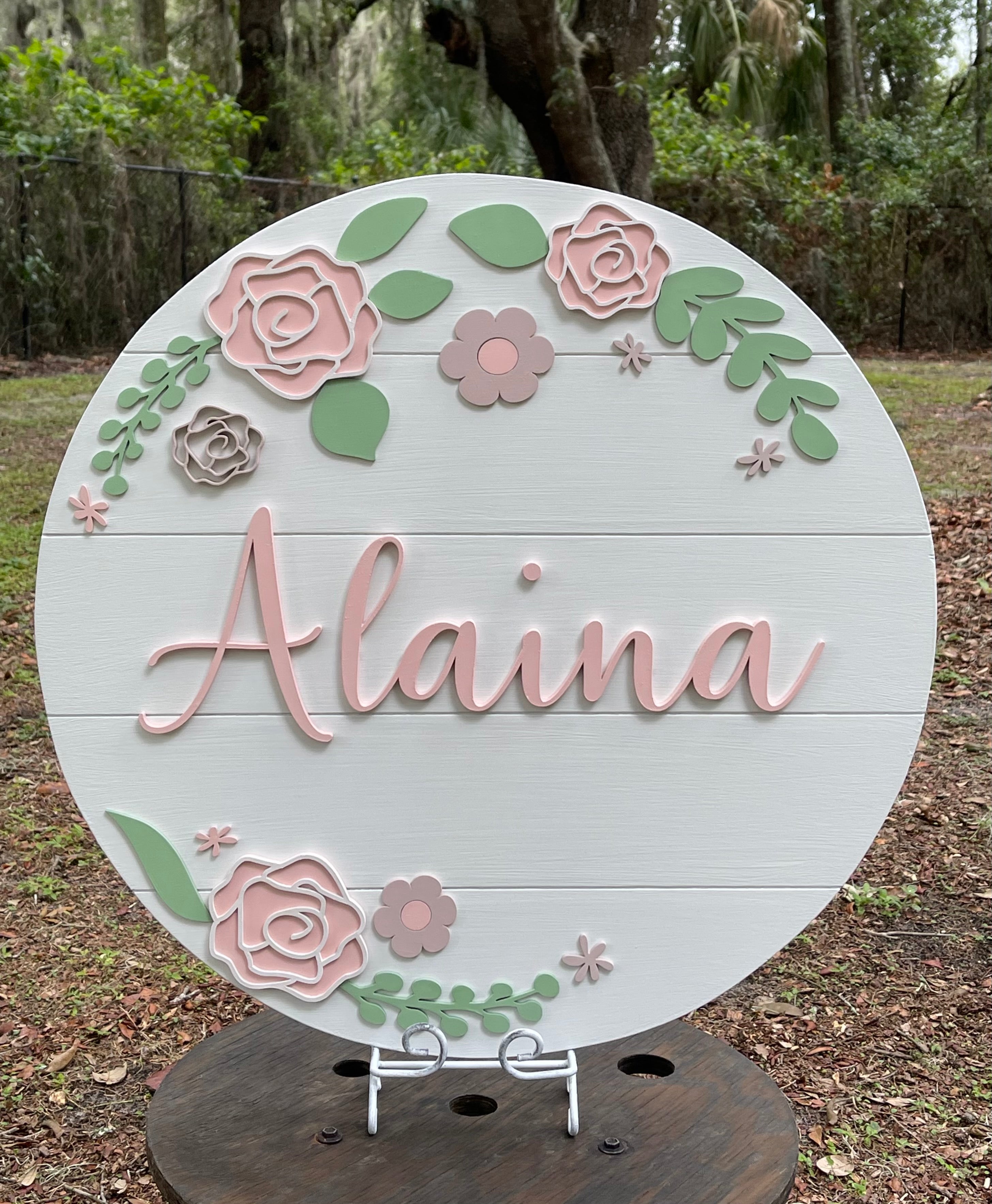 Nursery Baby Name Sign is shown displayed outside on an easel so you can see the colors of the 3D wood.