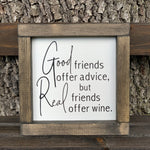 Good Friends Offer Advice, But Real Friends Offer Wine (Script Version) shows the sign sitting outside on a ladder.