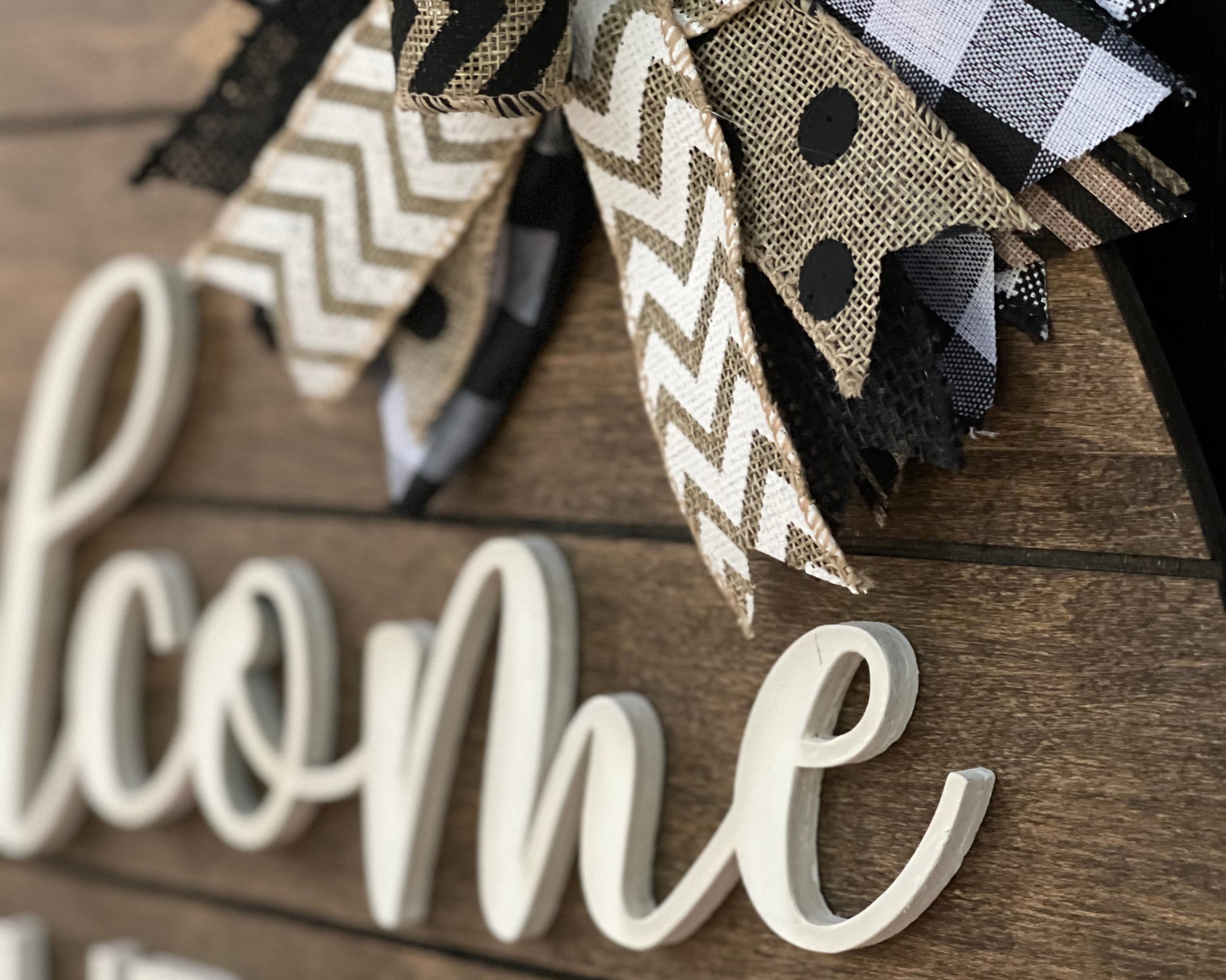 This image shows a close up of the 3D white wood cutout and burlap bow.