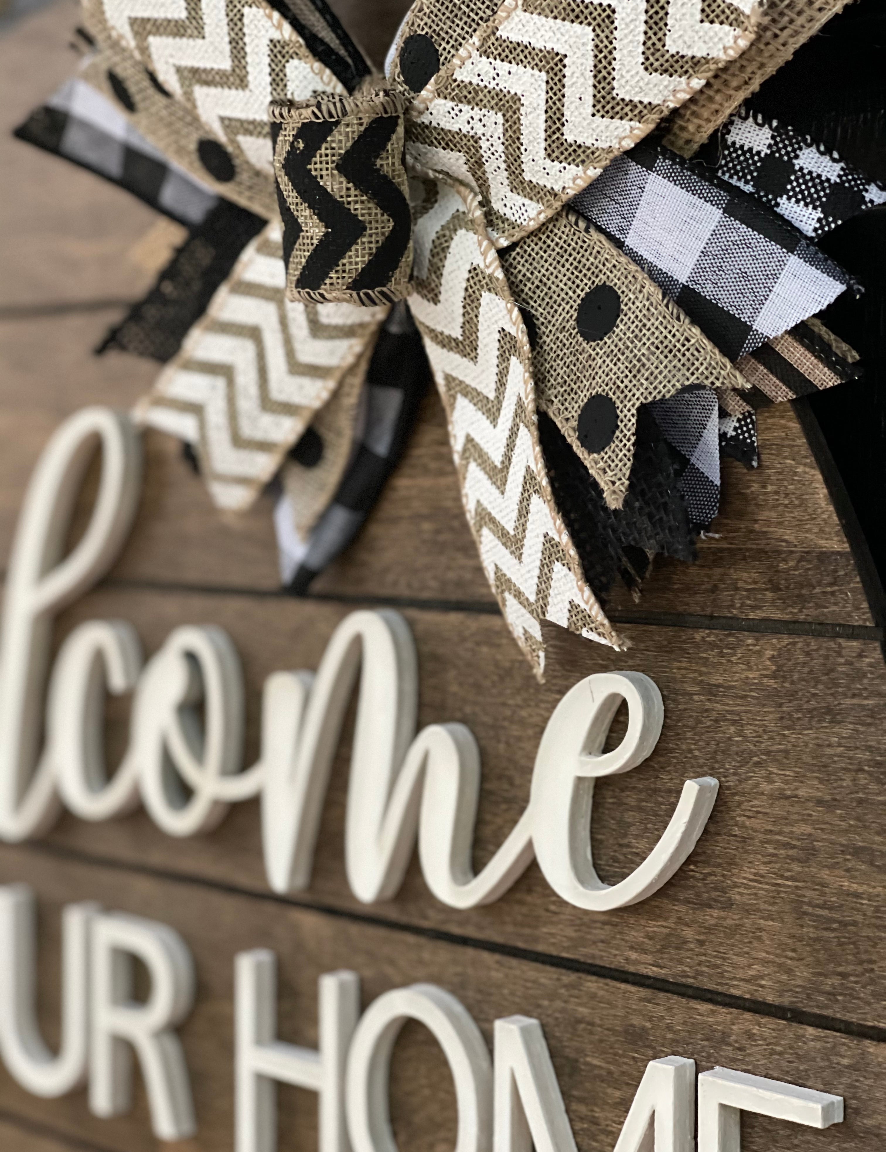 This image shows a close up of the 3D white wood cutout and burlap bow.