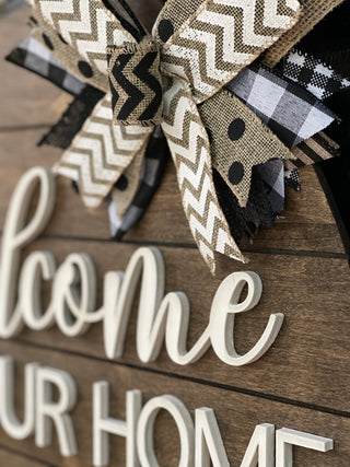 This image shows a close up of the 3D white wood cutout and burlap bow.