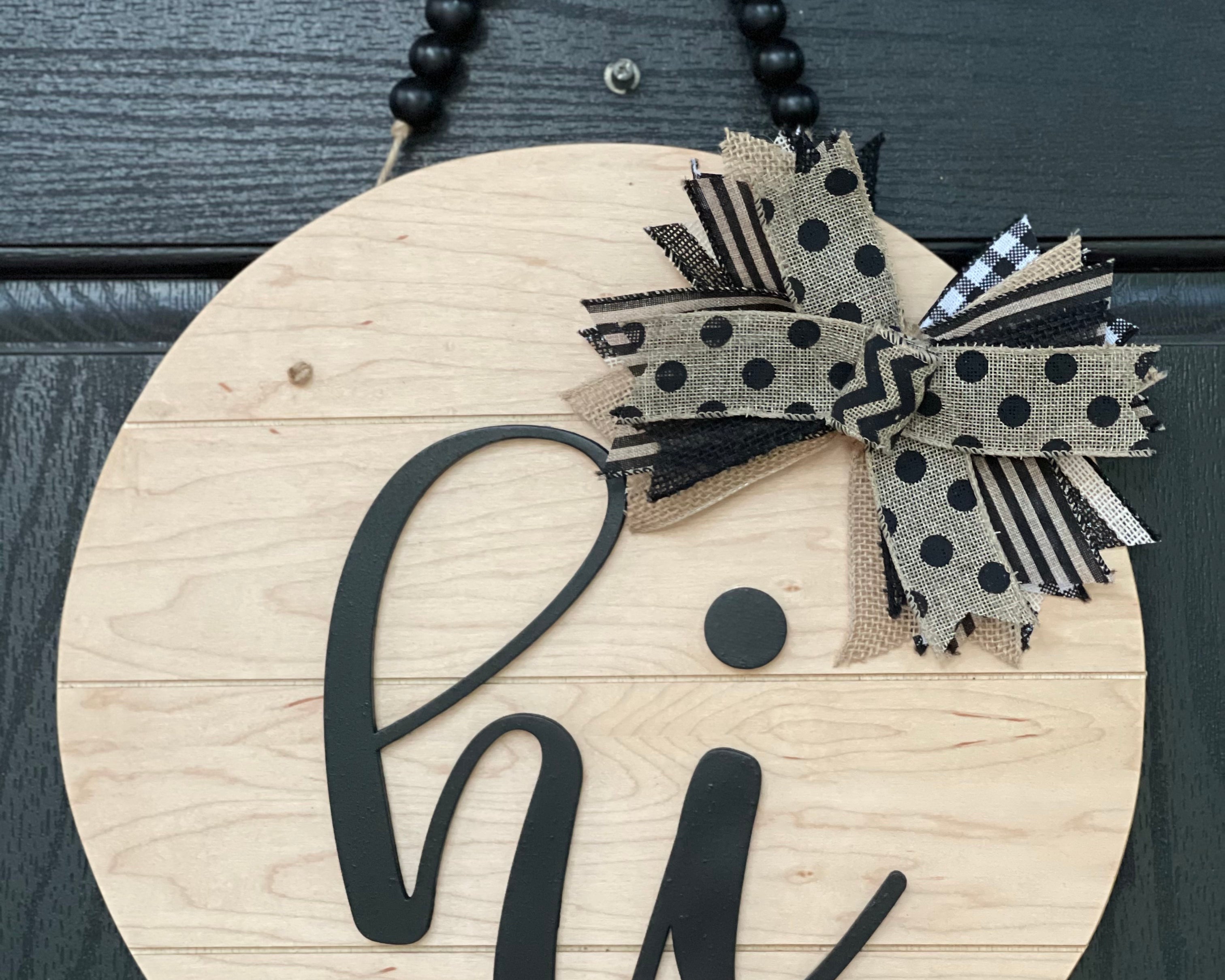 Hi shiplap front door hanger is shown hanging on a black door.  This is the 15" round sign.