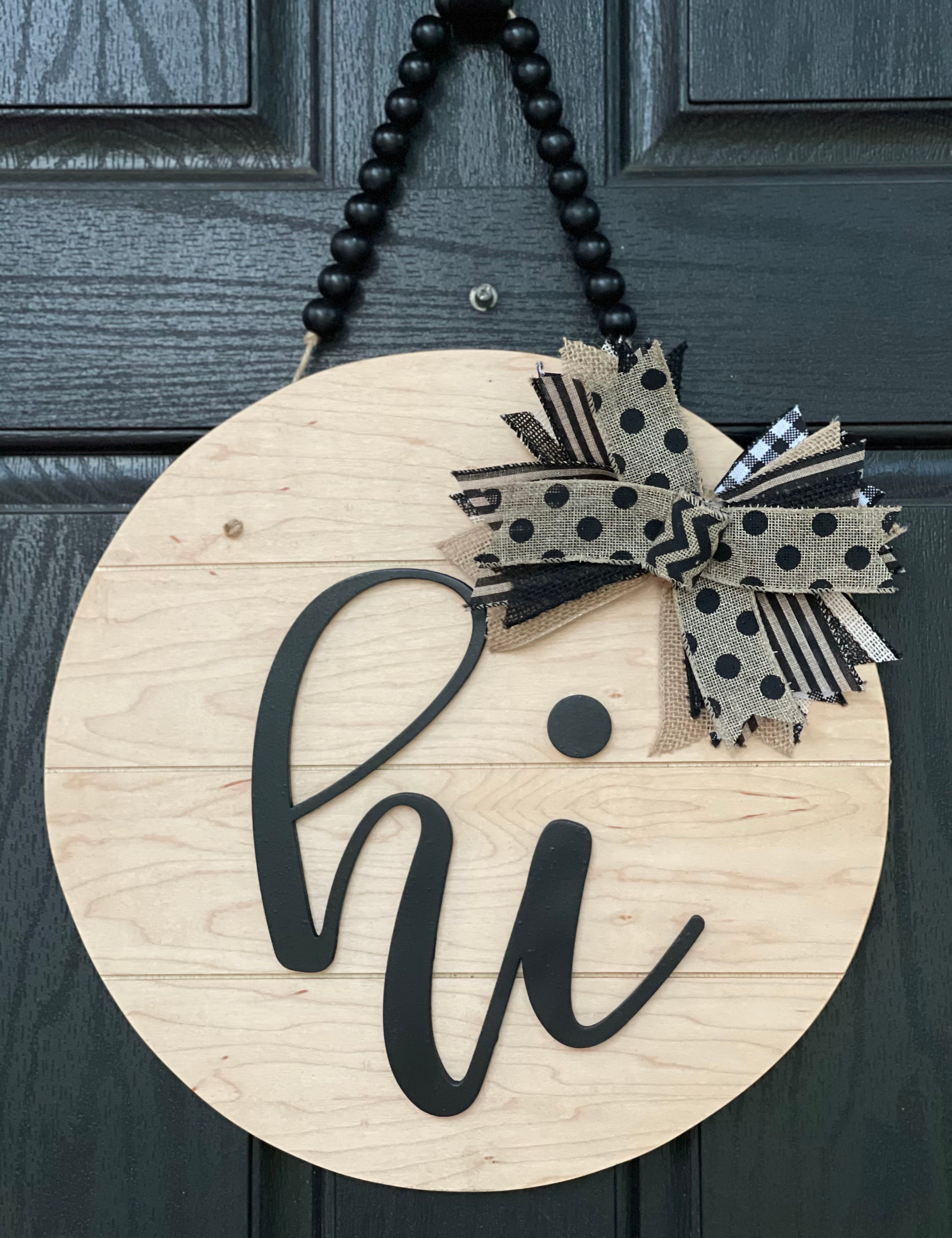 Hi shiplap front door hanger is shown hanging on a black door.  This is the 15" round sign.