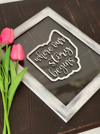 This image shows the glass frame with the 3D wood cutouts.  There is no hook on the back.  You can purchase command hooks if you'd like to hang the sign.