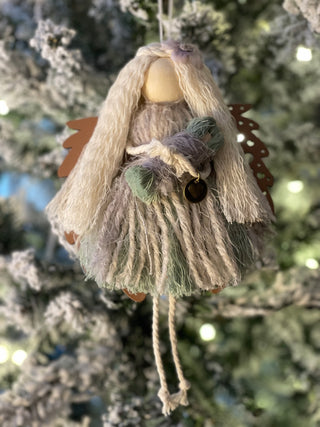 This is the sage macrame angel with blonde hair holding her baby with the walnut wood angel wings.