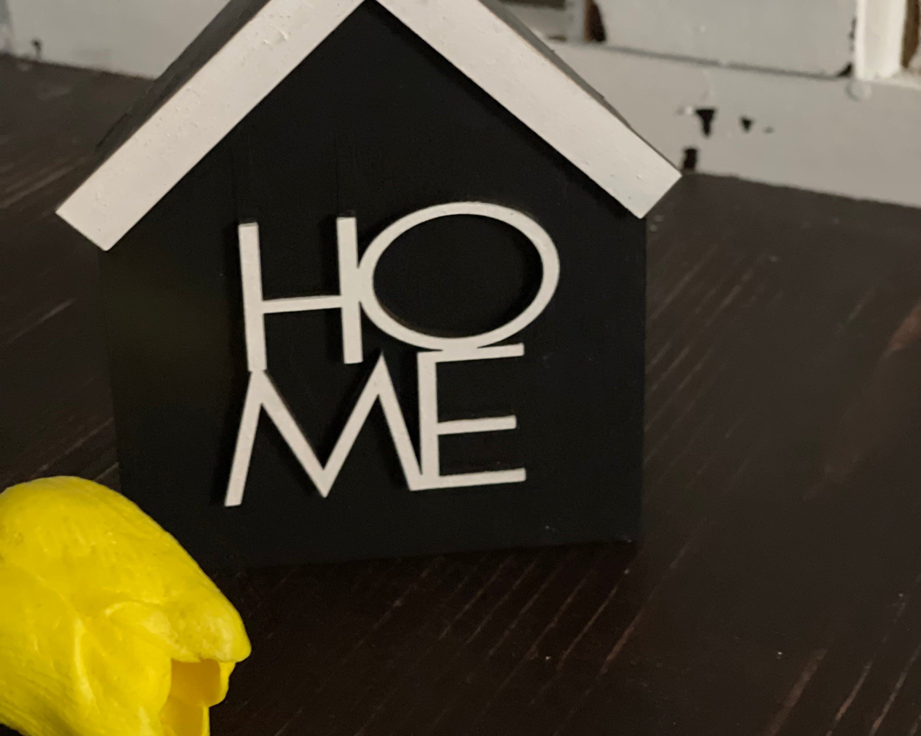 This image show the black HOME sign.