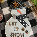 This image shows the small gray snowman that says let it snow in print.