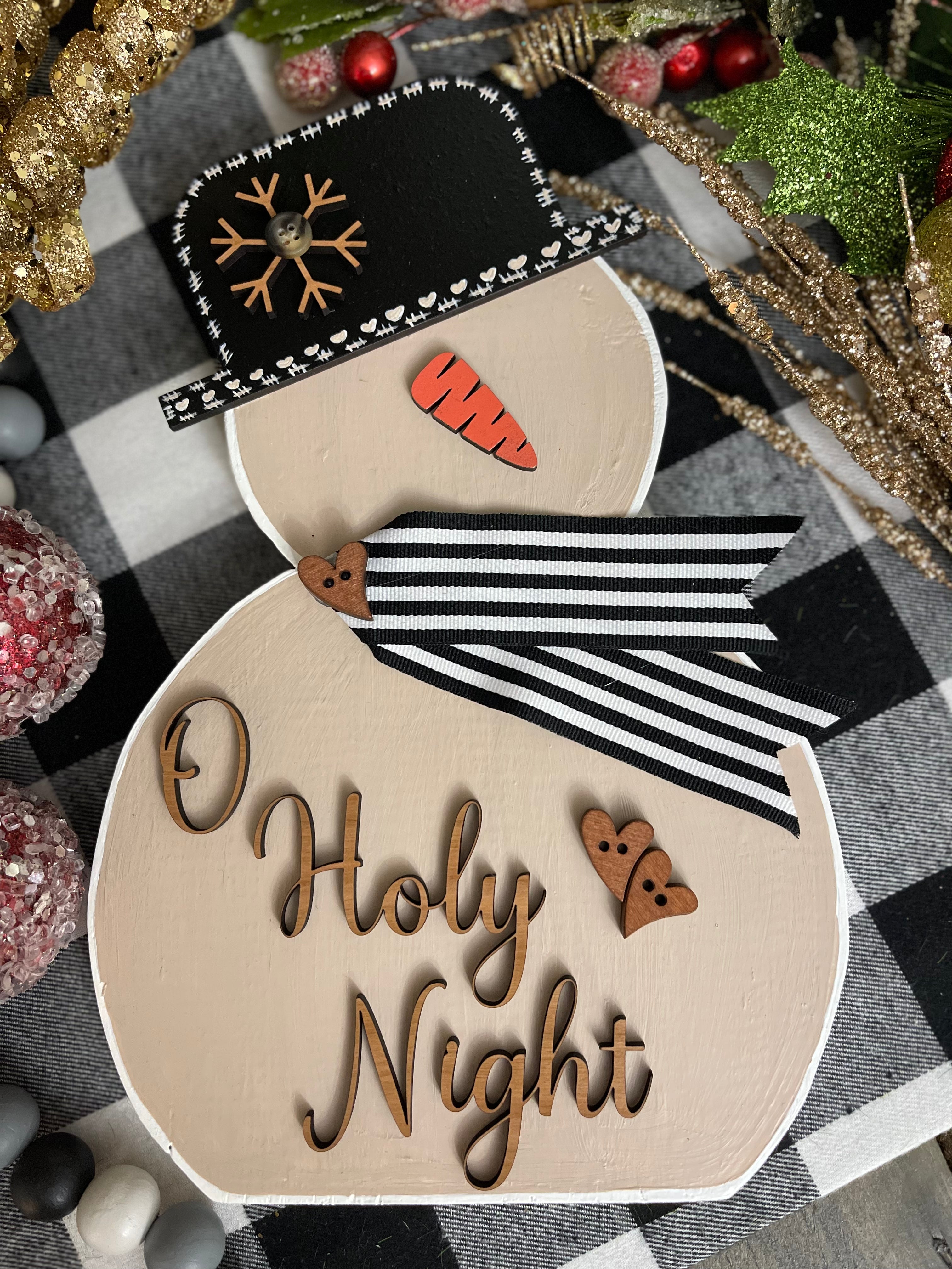 This image shows the large tan snowman with the saying O Holy Night.