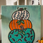 This image shows the final DIY painted design of the pumpkin trio, 