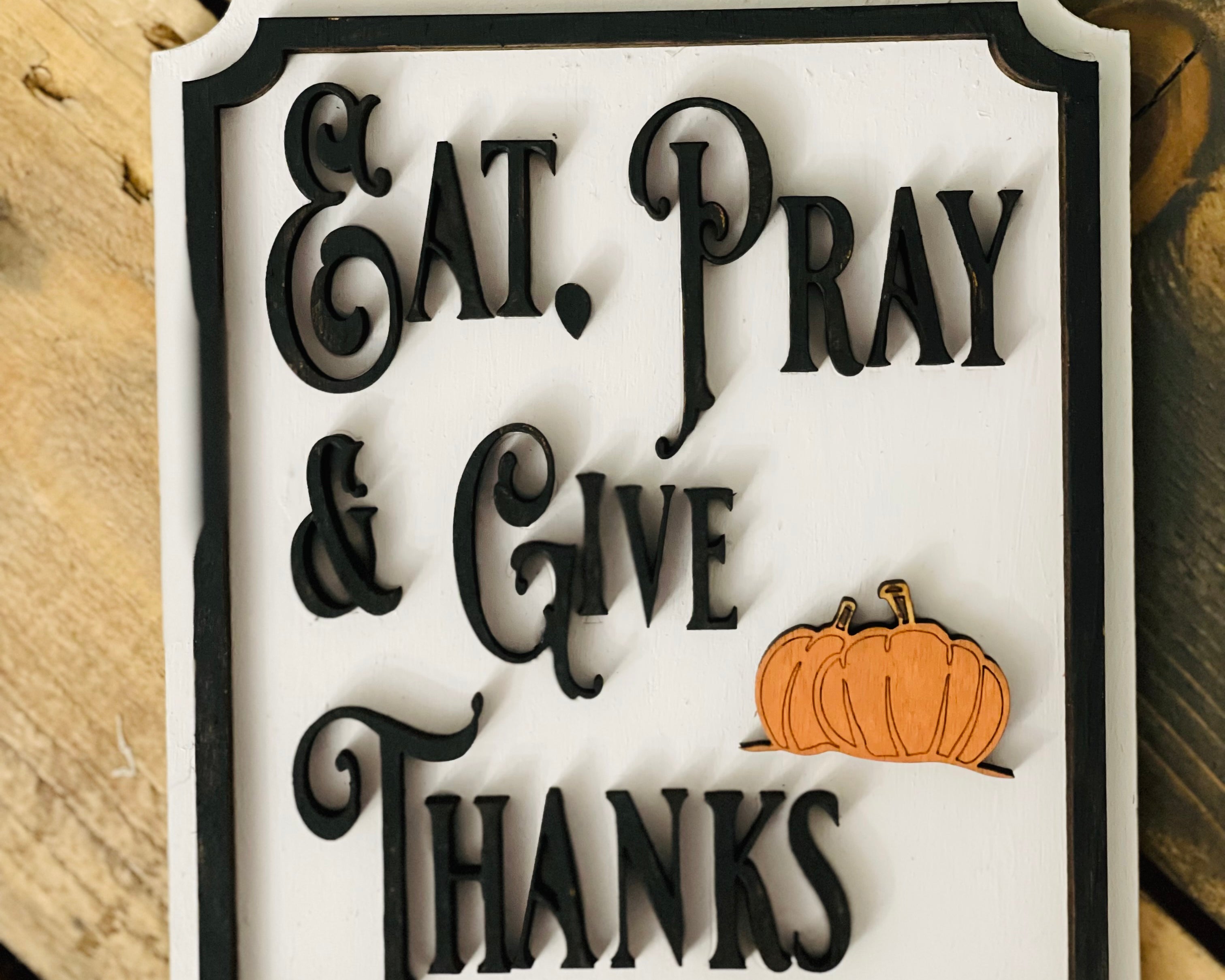 This image show the Eat, Pray & Give Thanks mini sign with a 3D orange pumpkin cutout.