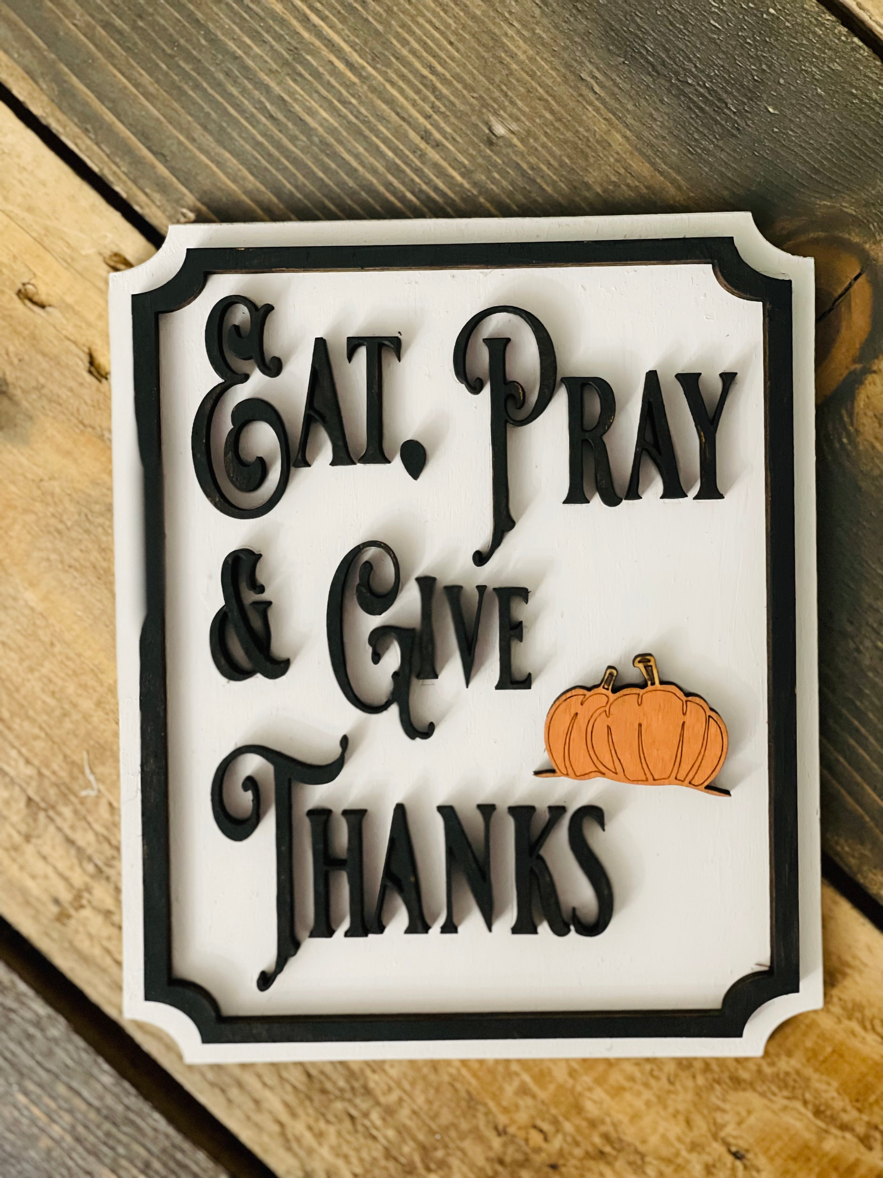 This image show the Eat, Pray & Give Thanks mini sign with a 3D orange pumpkin cutout.