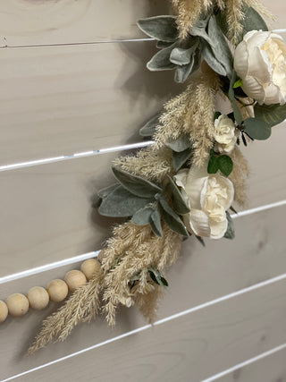 This image is another close up of the floral arrangements with the wooden beads.
