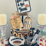 Thanksgiving Tiered Tray Set of five includes the Eat, Pray and Give Thanks Sign, a mini engraved cutting board, a mini silverware gift tag, a 3D wood engraved baked daily fresh pie sign, and the pumpkin 3D gather banner.