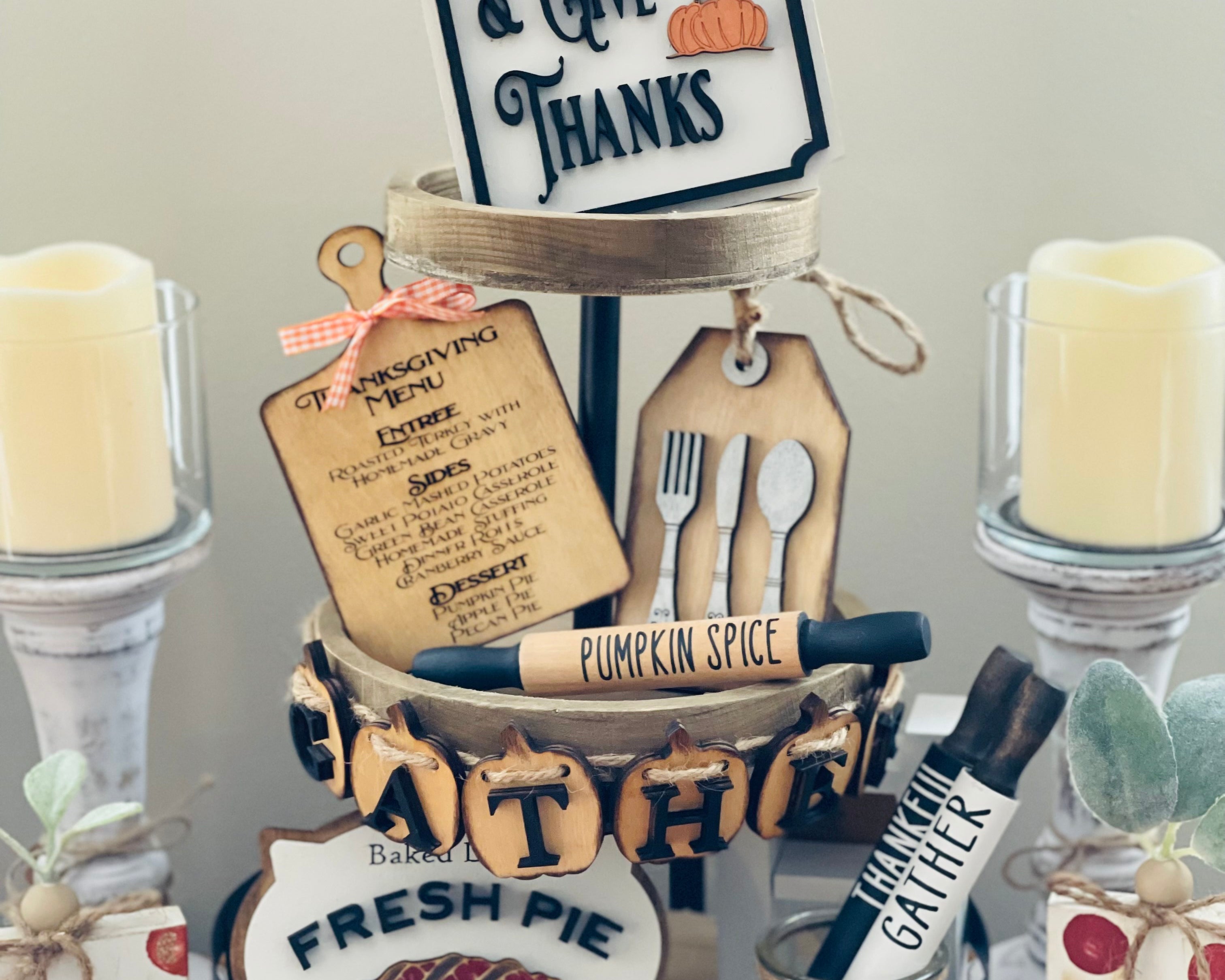 Thanksgiving Tiered Tray Set of five includes the Eat, Pray and Give Thanks Sign, a mini engraved cutting board, a mini silverware gift tag, a 3D wood engraved baked daily fresh pie sign, and the pumpkin 3D gather banner.