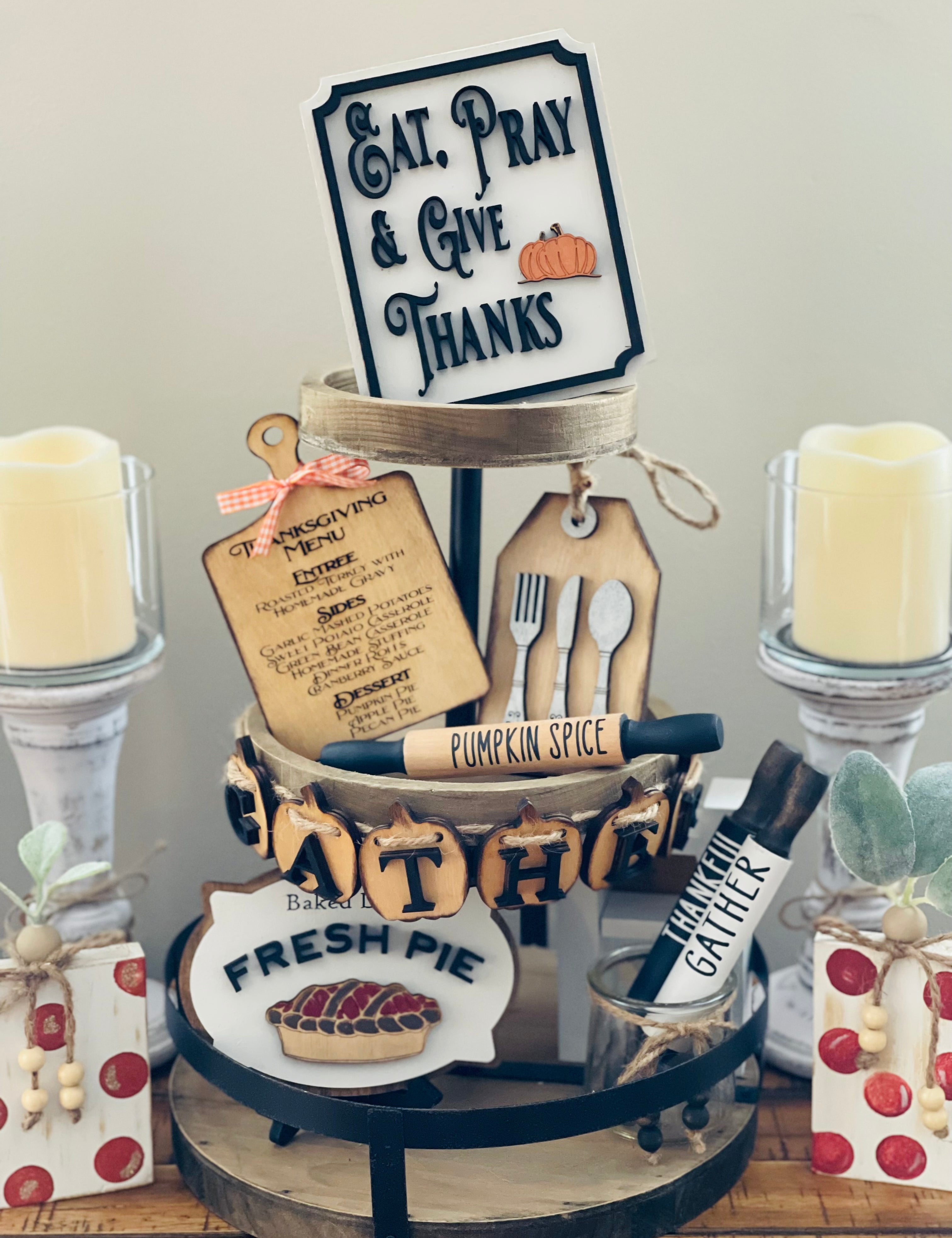 Thanksgiving Tiered Tray Set of five includes the Eat, Pray and Give Thanks Sign, a mini engraved cutting board, a mini silverware gift tag, a 3D wood engraved baked daily fresh pie sign, and the pumpkin 3D gather banner.