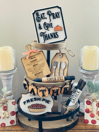 Thanksgiving Tiered Tray Set of five includes the Eat, Pray and Give Thanks Sign, a mini engraved cutting board, a mini silverware gift tag, a 3D wood engraved baked daily fresh pie sign, and the pumpkin 3D gather banner.