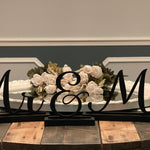 This image shows a close up of the Mr. & Mrs. 3D wood script signs.