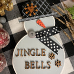 This image shows the small gray snowman that says jingle bells.