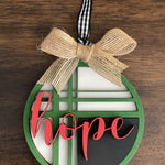 This is the red, green, black and white hope ornament with a twine bow.