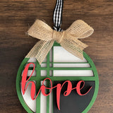 This is the red, green, black and white hope ornament with a twine bow.