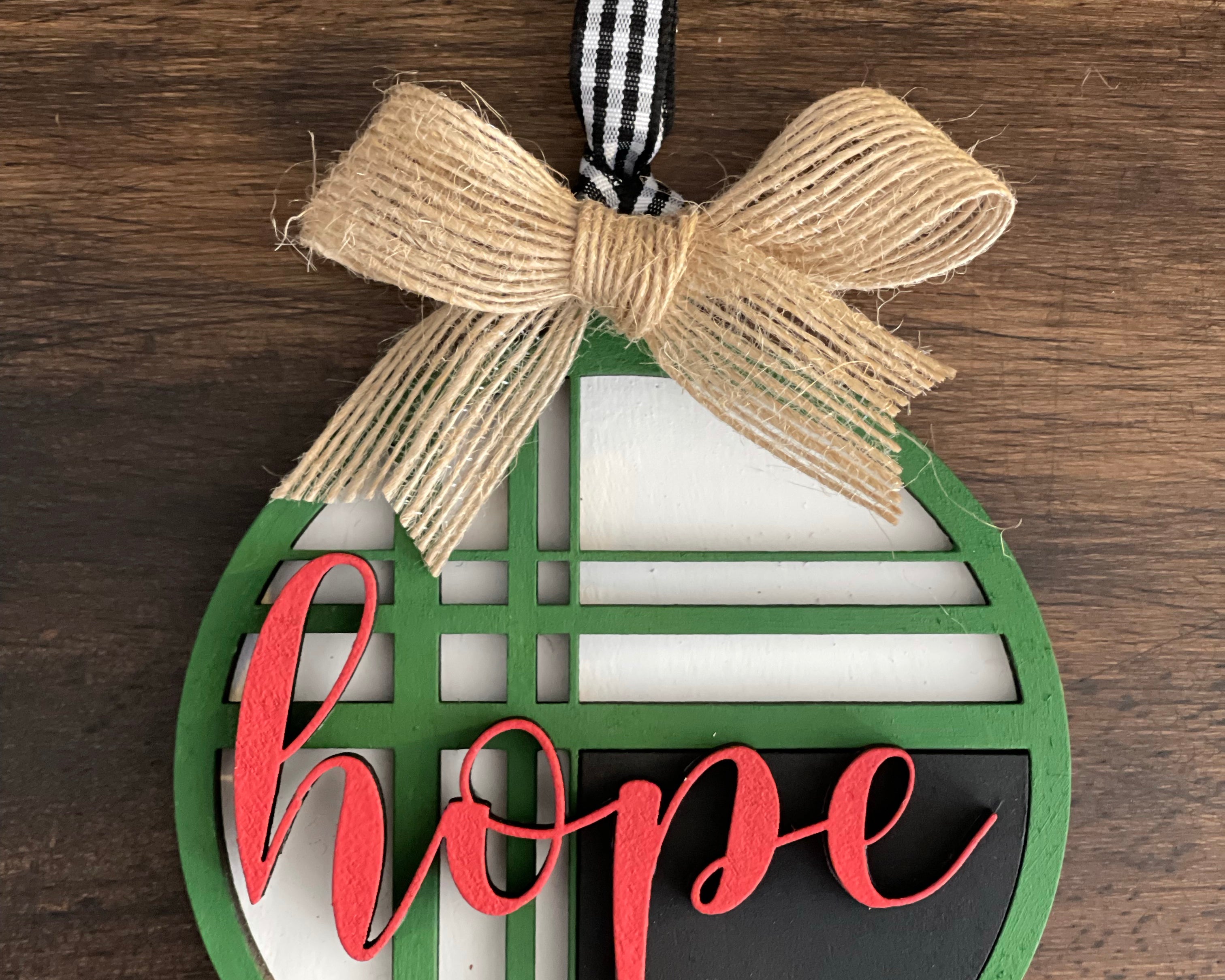 This is the red, green, black and white hope ornament with a twine bow.