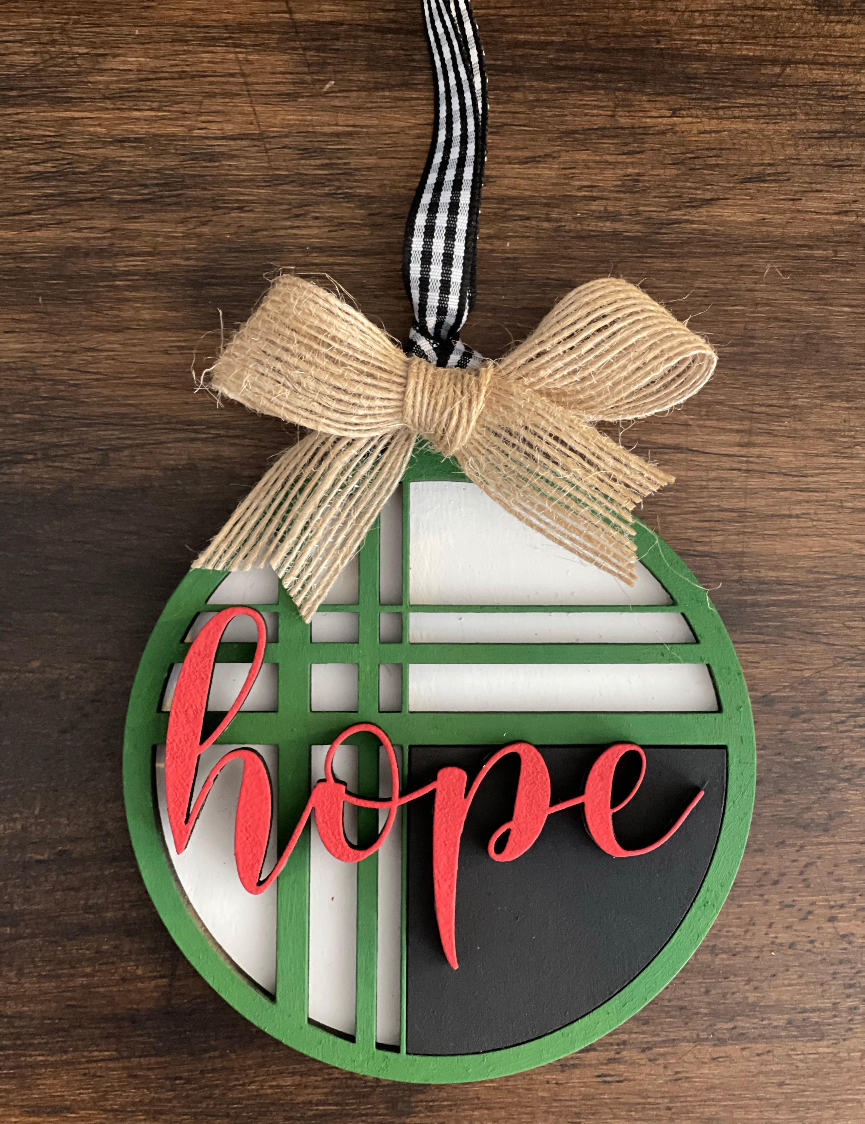This is the red, green, black and white hope ornament with a twine bow.