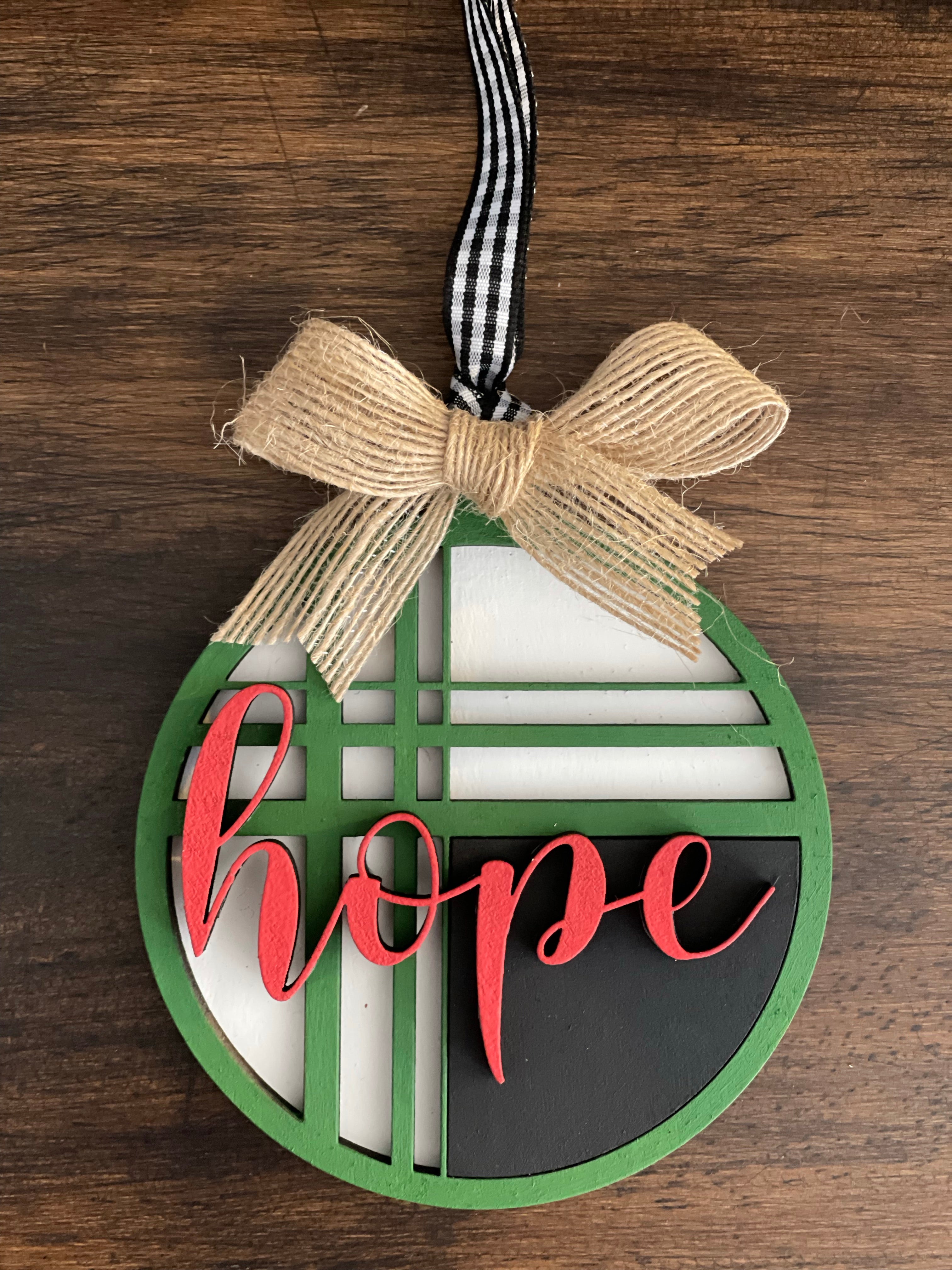 This is the red, green, black and white hope ornament with a twine bow.