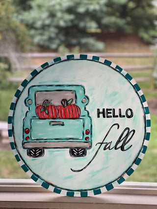 This image shows the DIY finished door hanger in an outdoor setting.  No physical product will be shipped.  You will only receive a digital download for the transfer image and a list of supplies used, as well as a step by step video of this DIY.