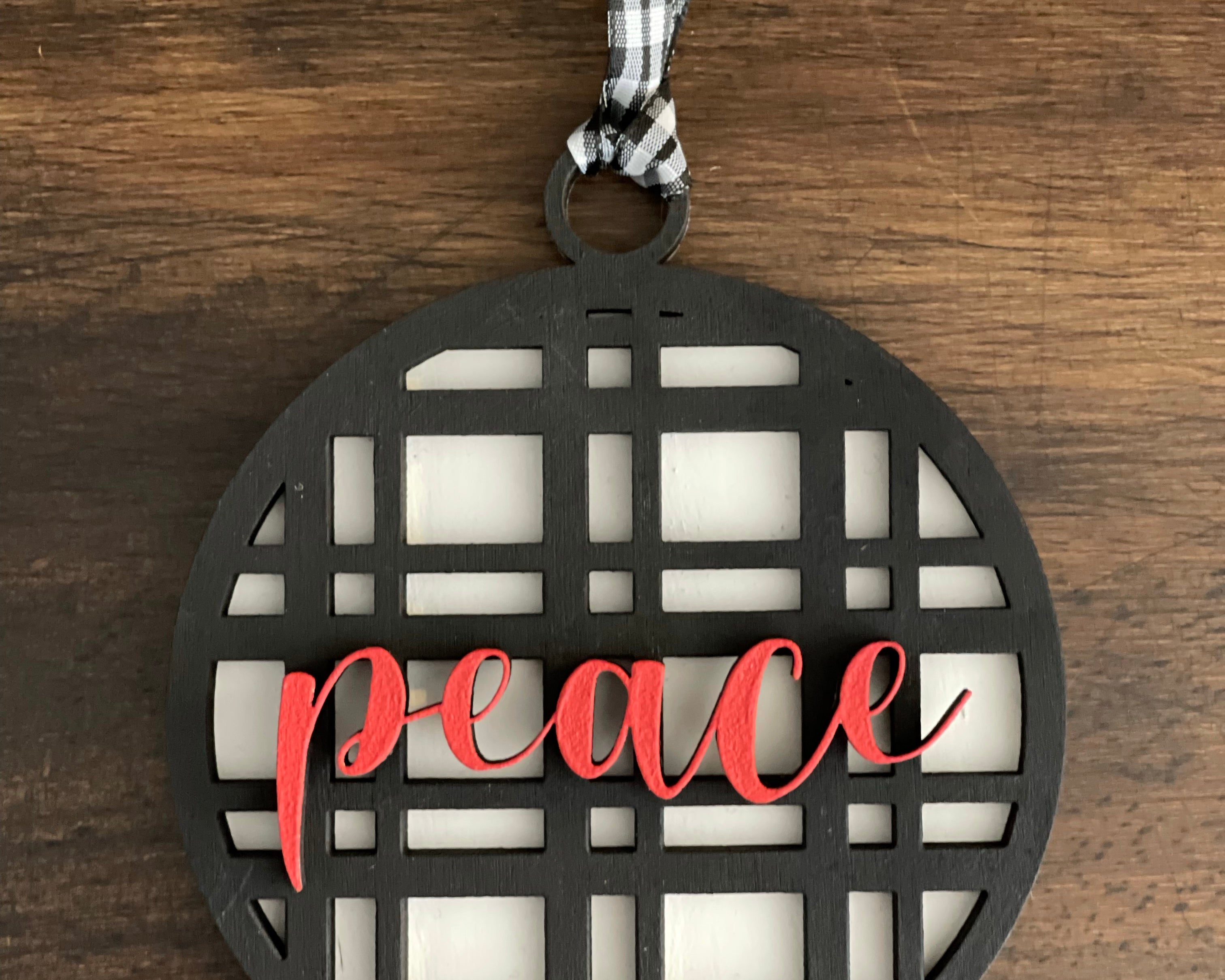 This is the black plaid peace ornament without a twine bow.