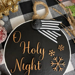 This image shows the large black O Holy Night.