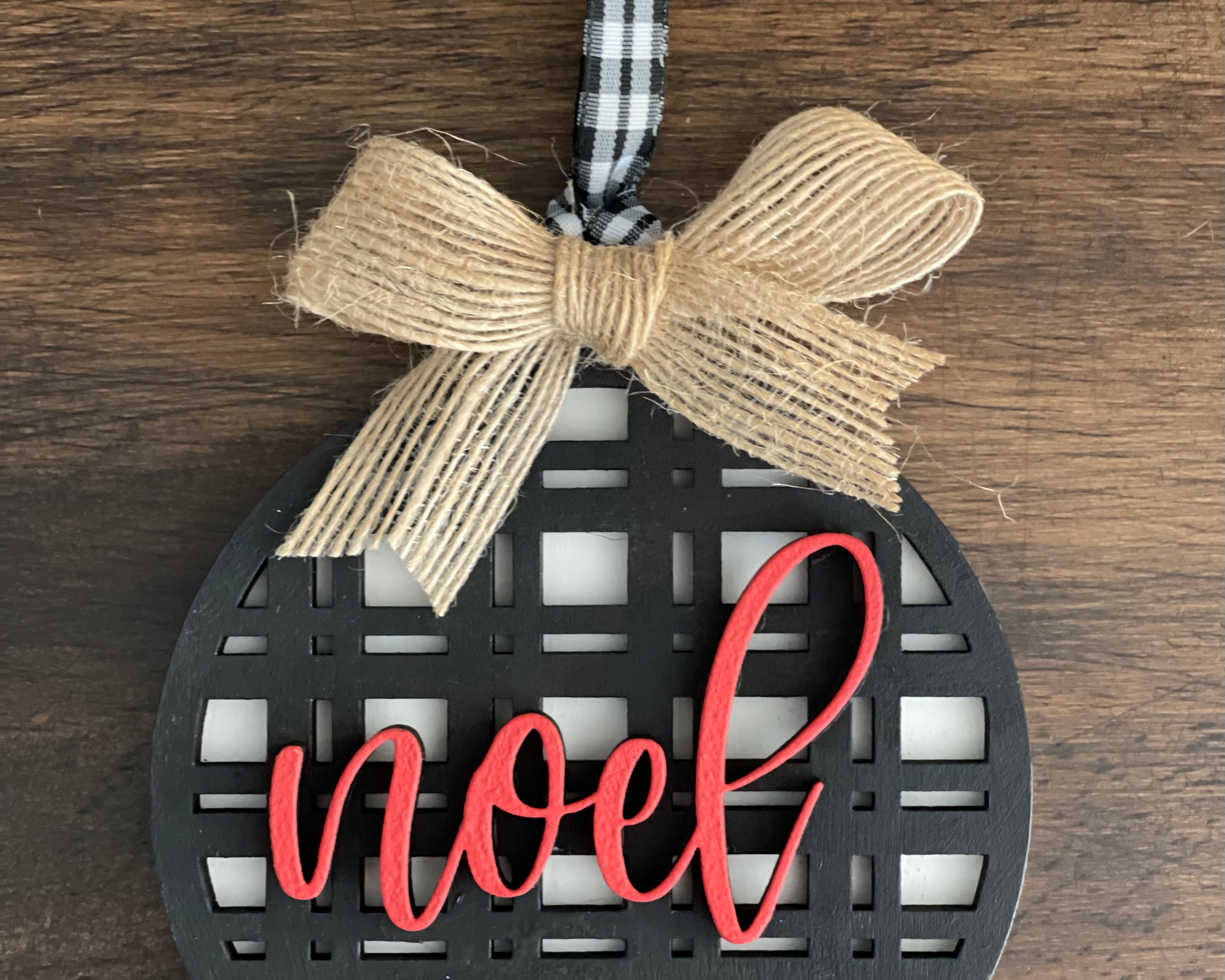 This is the black plaid noel ornament with a twine bow,