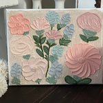This beautiful design has 12 flowers adorning the canvas.  Bright pink, mauve, peach, and baby blue with greenery make this sign pop.  