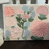 This beautiful design has 12 flowers adorning the canvas.  Bright pink, mauve, peach, and baby blue with greenery make this sign pop.  