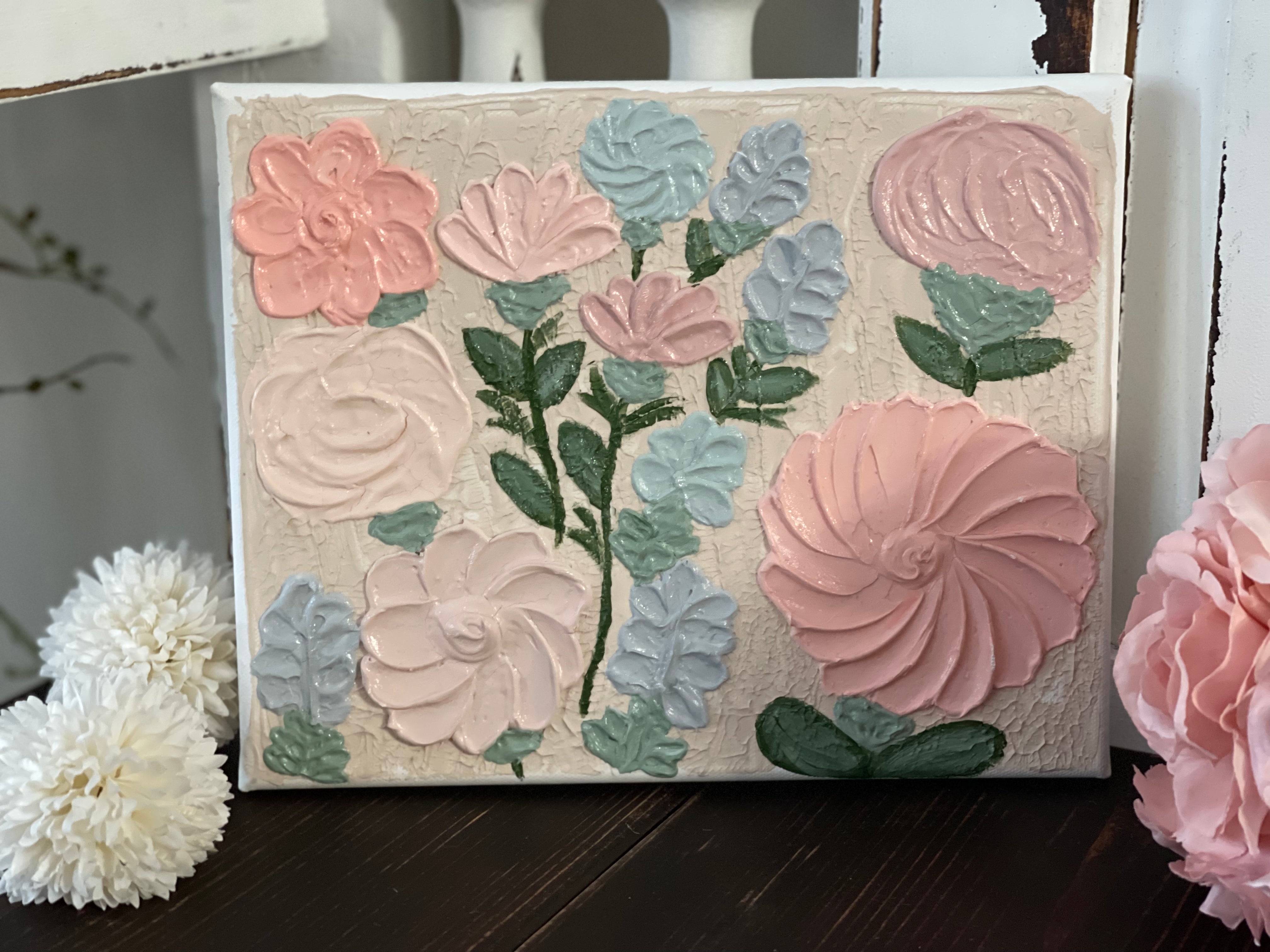 This beautiful design has 12 flowers adorning the canvas.  Bright pink, mauve, peach, and baby blue with greenery make this sign pop.  