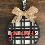 This is the black plaid peace ornament with a twine bow.