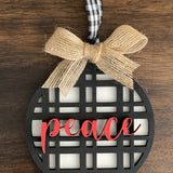 This is the black plaid peace ornament with a twine bow.