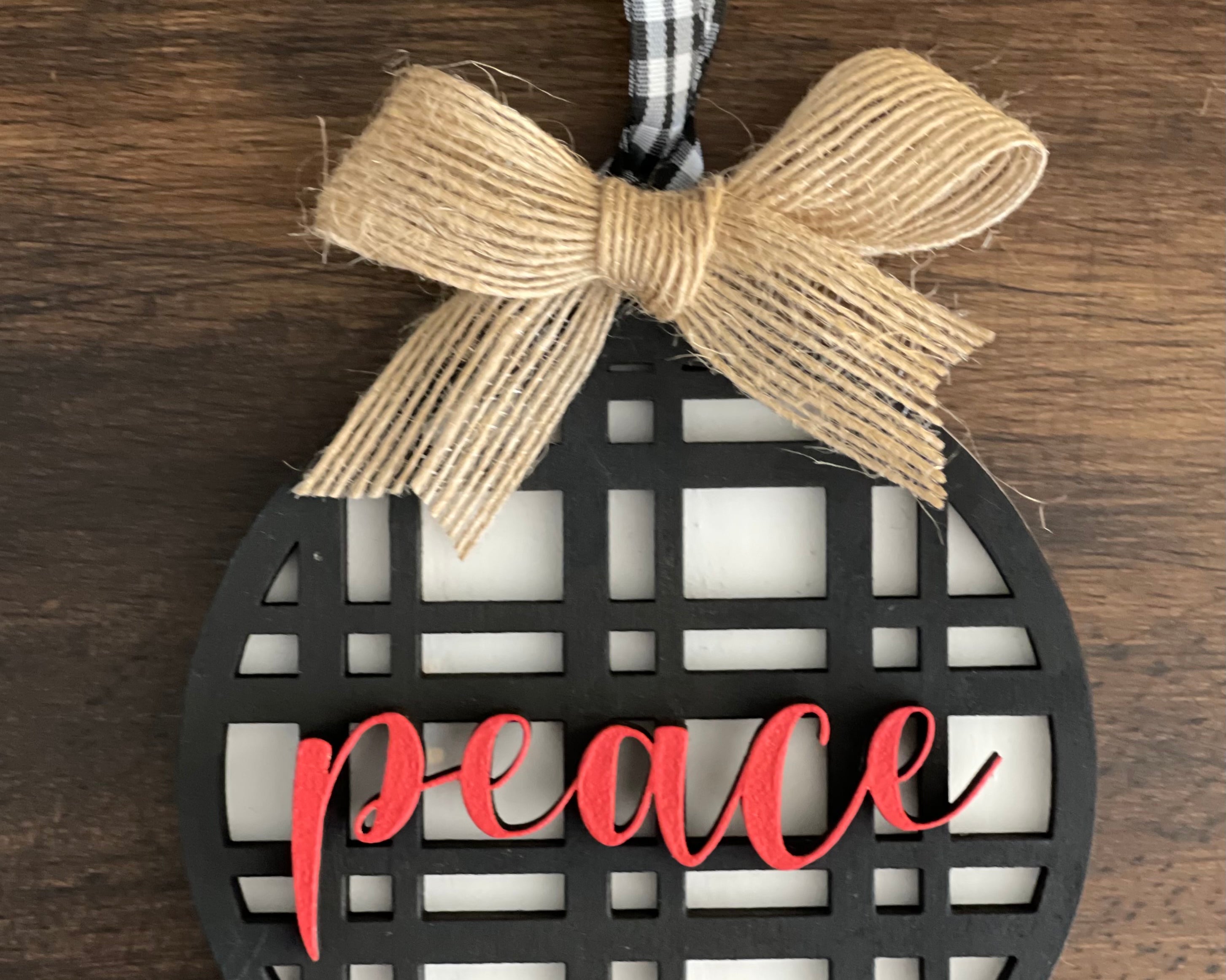 This is the black plaid peace ornament with a twine bow.