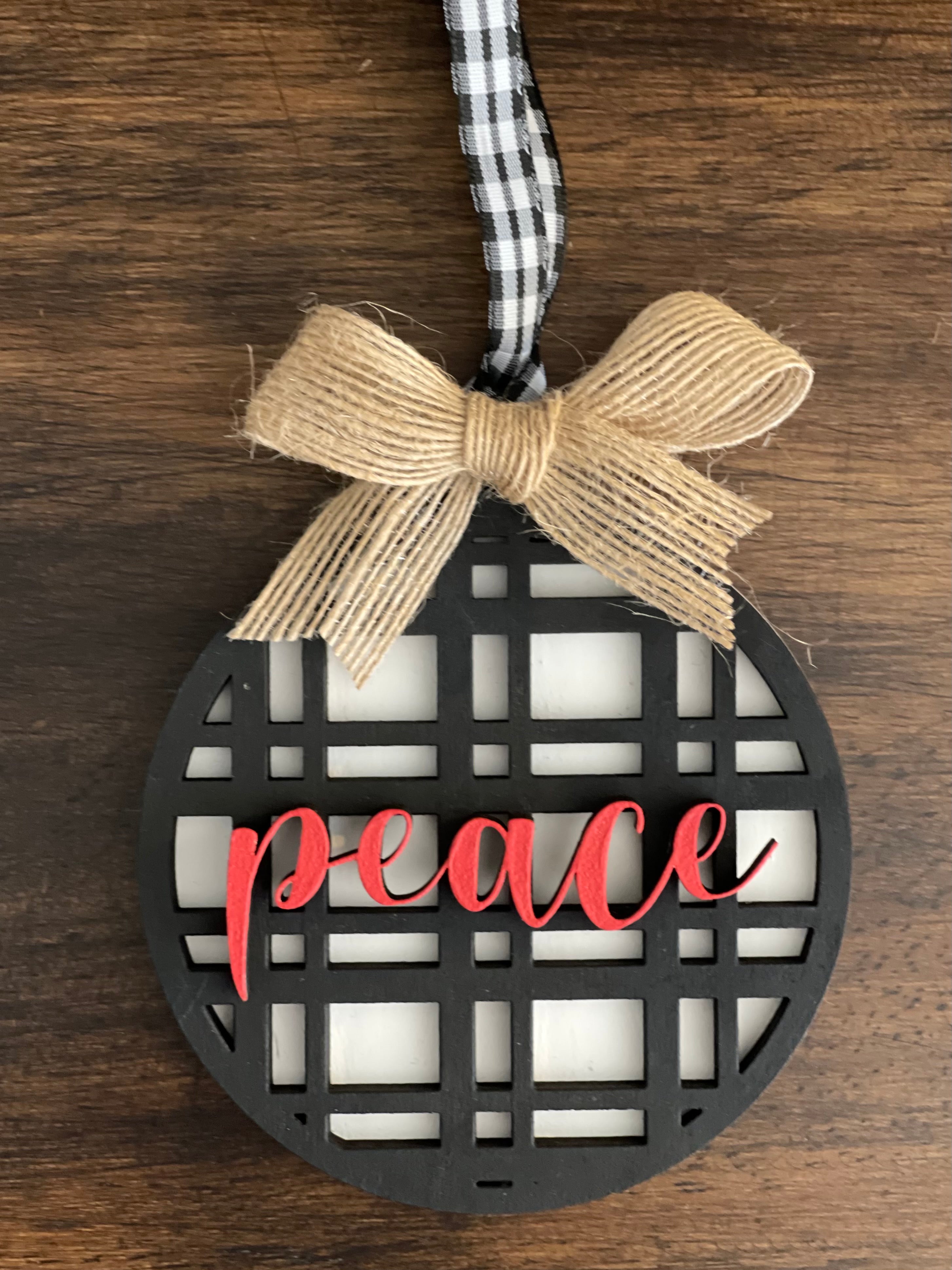 This is the black plaid peace ornament with a twine bow.