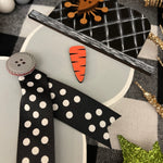 This image shows the small gray snowman's detailed painted hat.