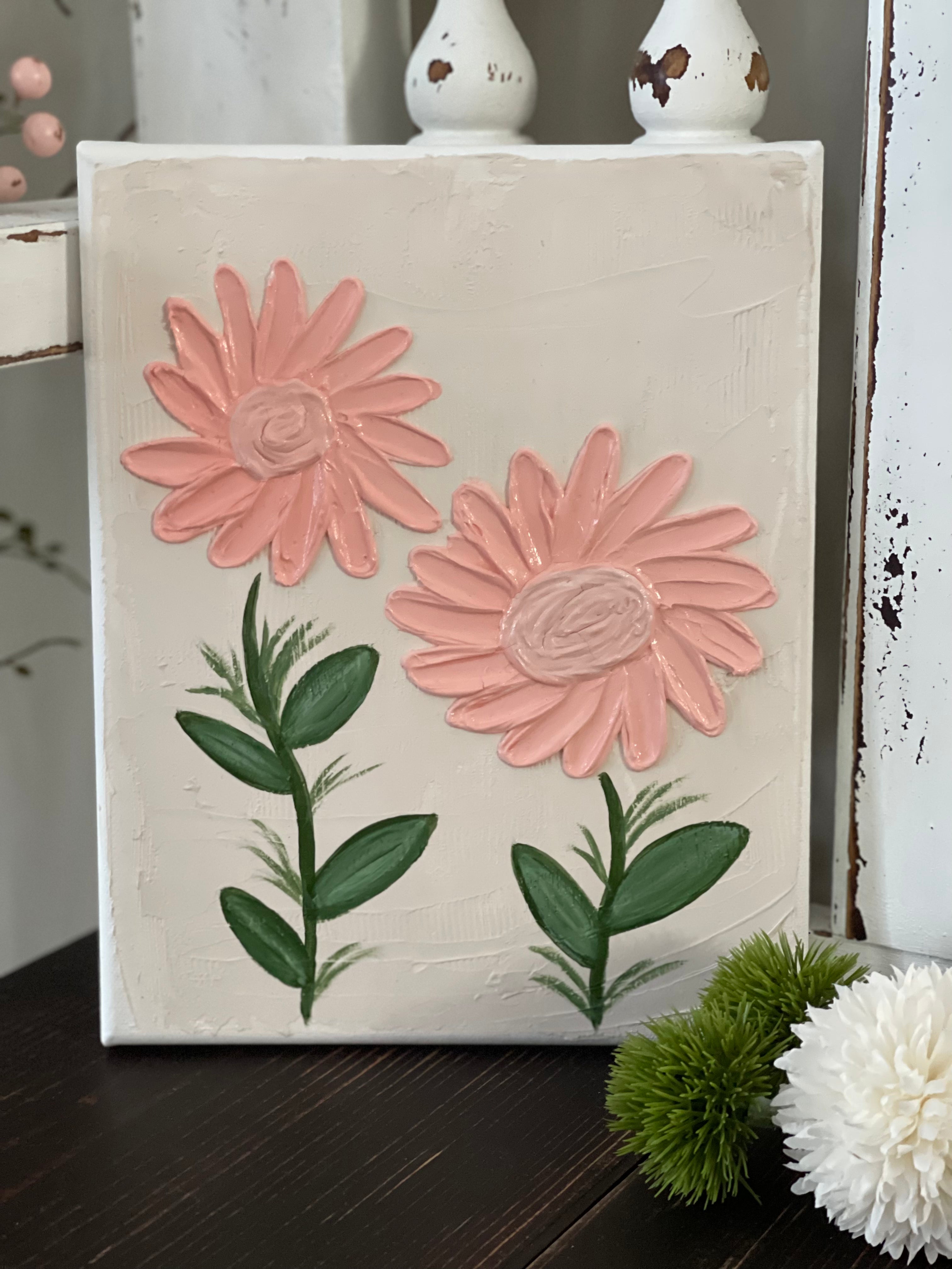 This image shows the hand painted textires pictire with details of the foral design. The flowers sre a pink/peach color, with green stems. 