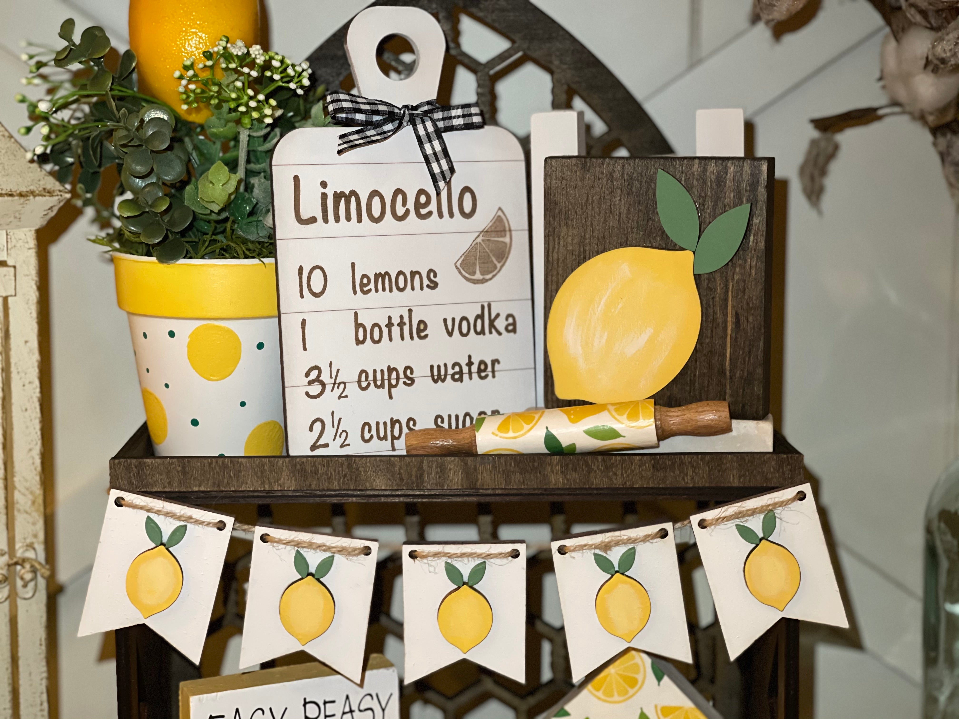 This image shows the white lemon banner hanging on our cathedral tiered tray.  It also has multiple lemon decor which is each sold separately.