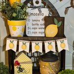 This image shows the cathedral tiered tray with multiple lemon themed decor.  Each item is sold separately on our website.